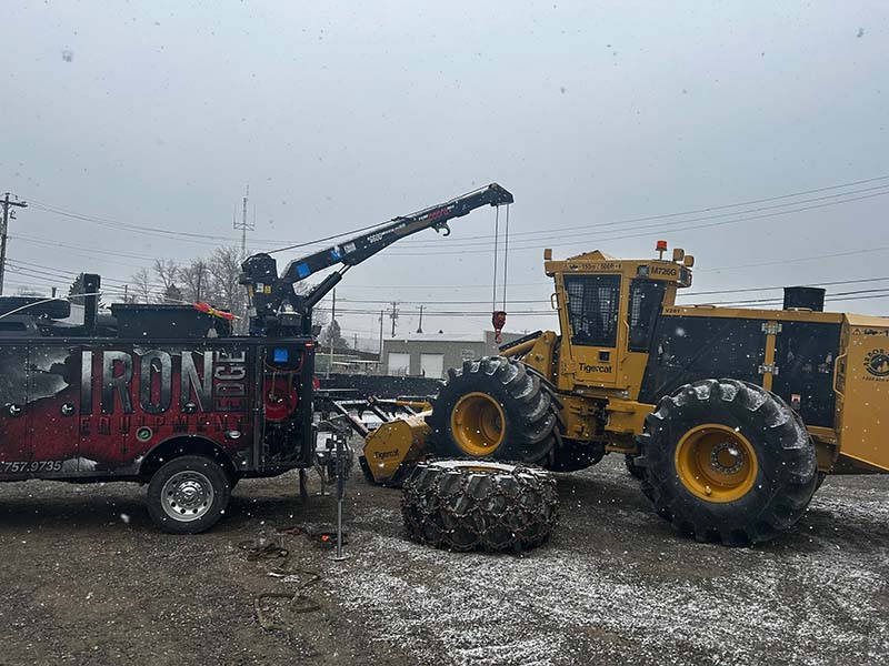 mobile serrvice truck hoisting a loader